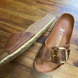 Classic one buckle Birkenstock slides in rich brown saddle leather with gold